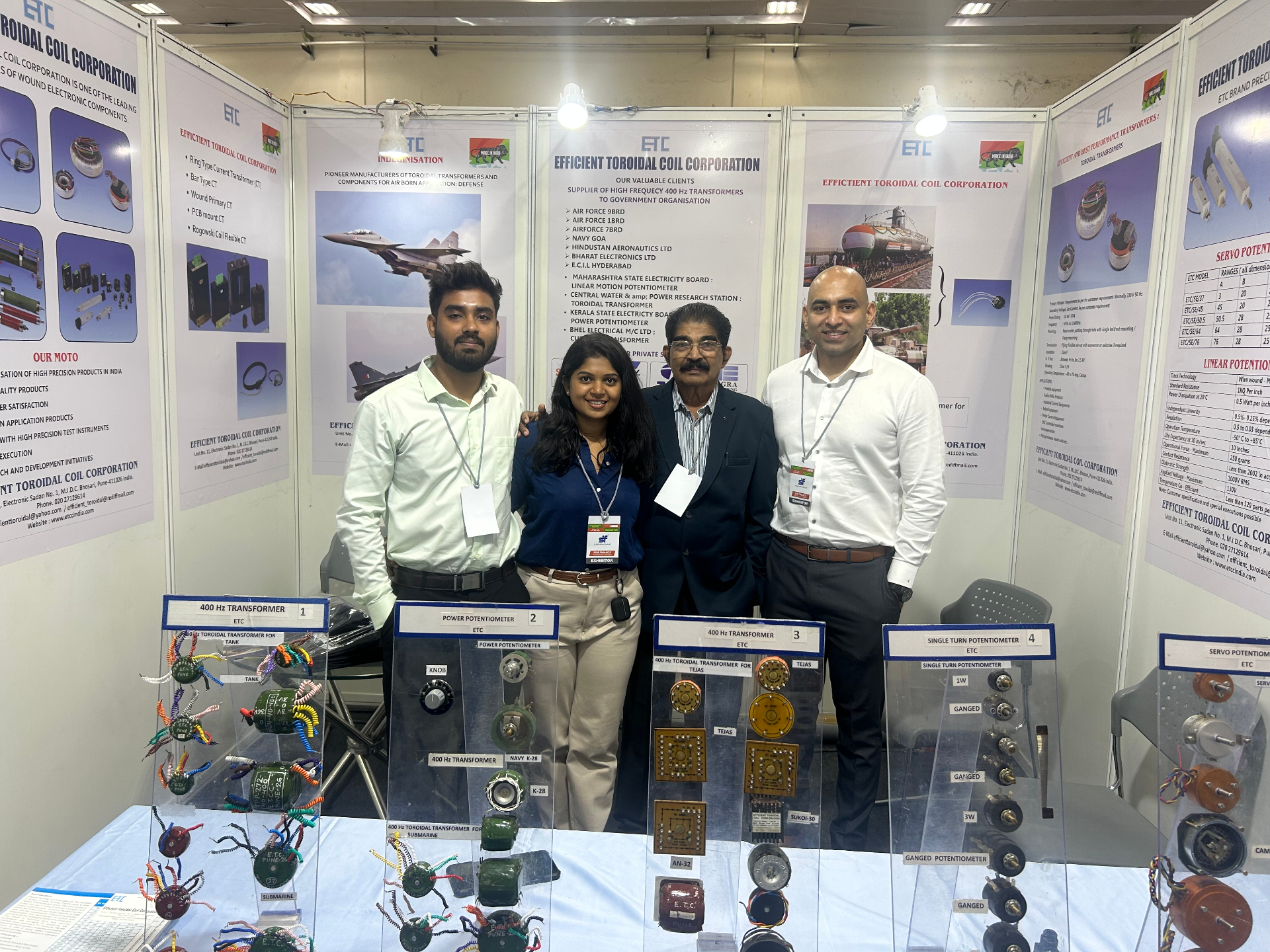 ETCC team at defence exhibition booth showcasing toroidal transformers, potentiometers, and electronic components